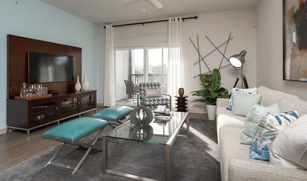 Spacious living room featuring modern furnishings and ample natural light at The Franklin Delray Apartments