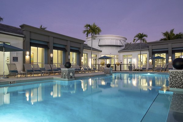 Resort-style pool with sun loungers at The Franklin Delray Apartments, offering luxury living near downtown