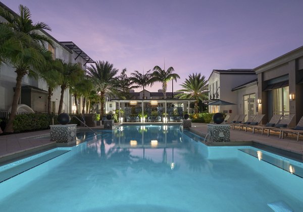 Rooftop pool with lounge seating at The Franklin Delray Apartments, offering luxury living and relaxation spaces