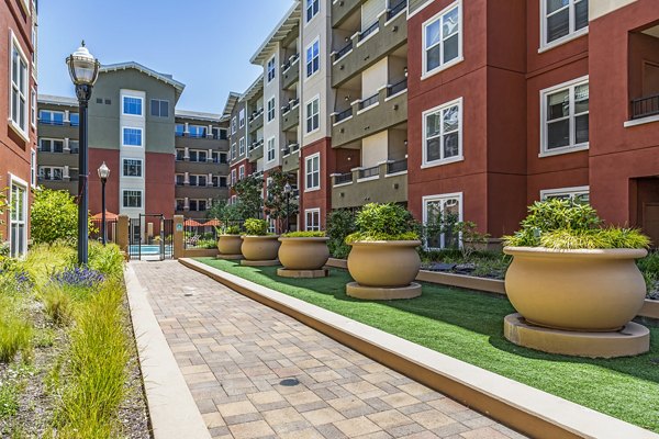 Acappella Apartments: Lush courtyard with seating and fountains at luxury apartments in a peaceful community