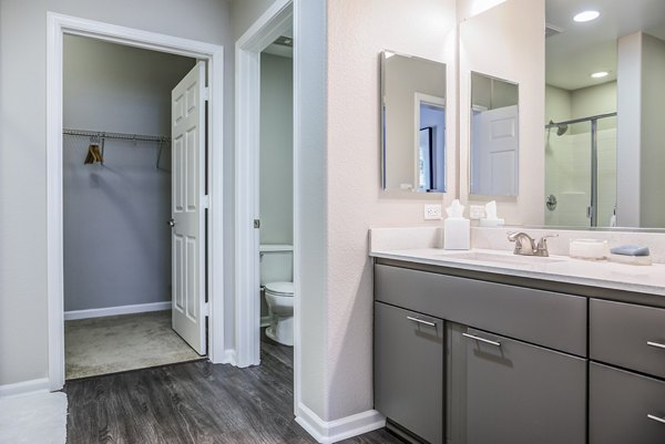 Modern bathroom with marble countertops at Acappella Apartments