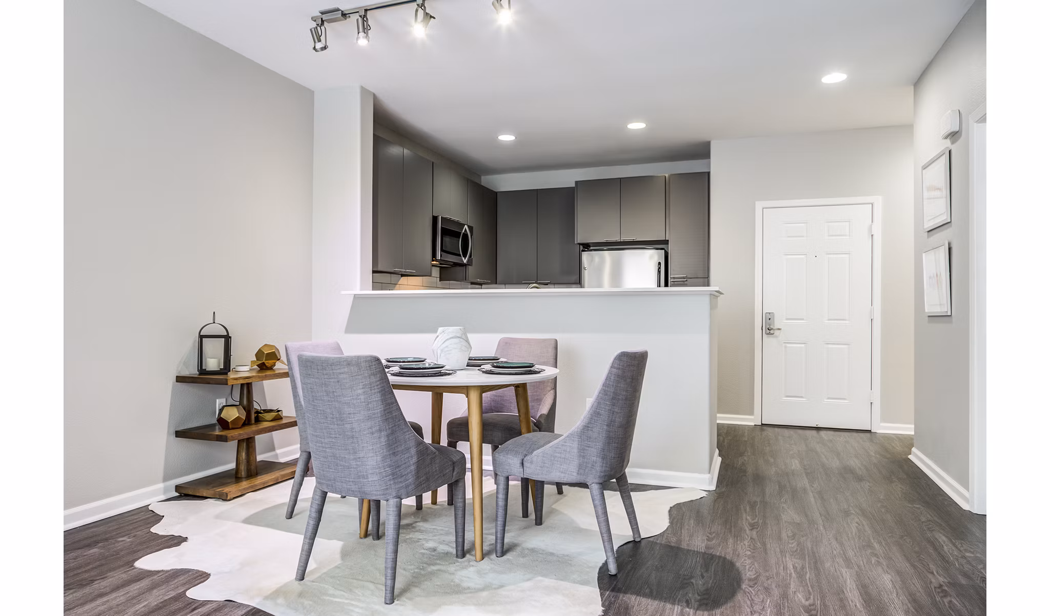 Dining room featuring modern furniture and elegant lighting at Acappella Apartments