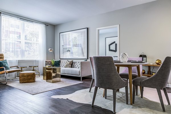 Dining area with modern furnishings and elegant lighting in Acappella Apartments