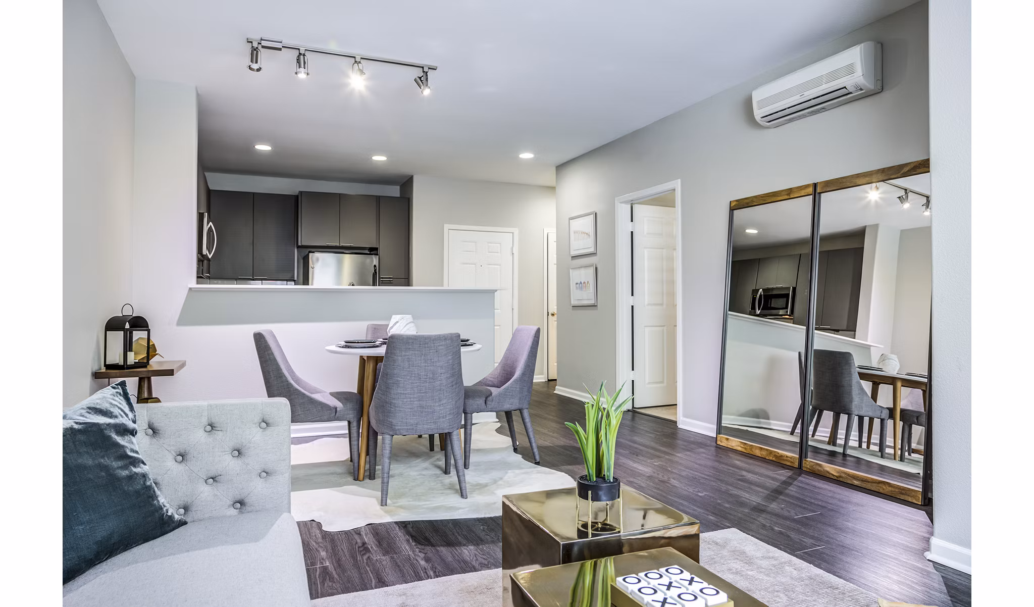Spacious living room with modern furnishings and large windows in Acappella Apartments, Greystar's luxury community