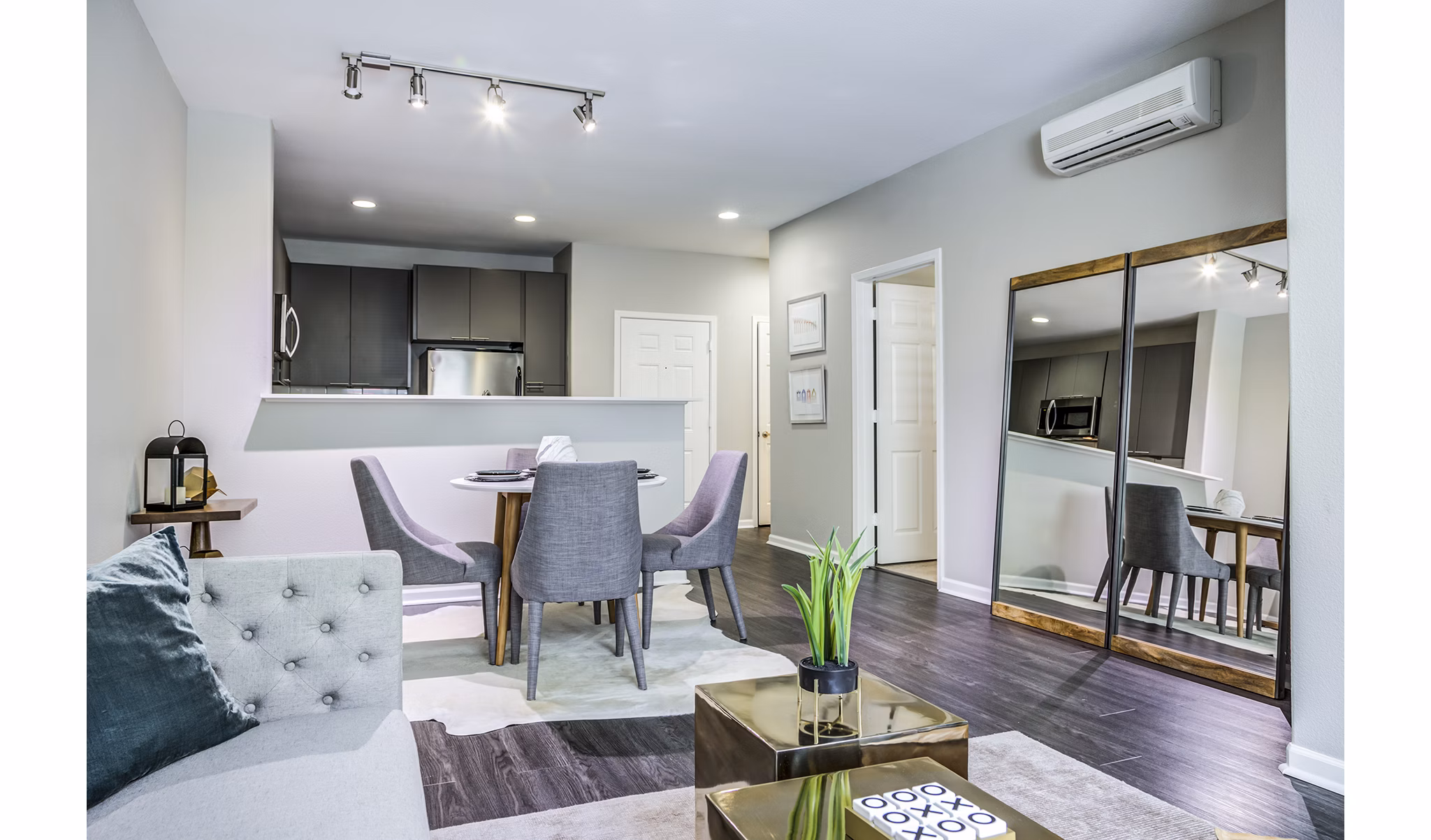 Spacious living room with modern furnishings and large windows in Acappella Apartments, Greystar's luxury community