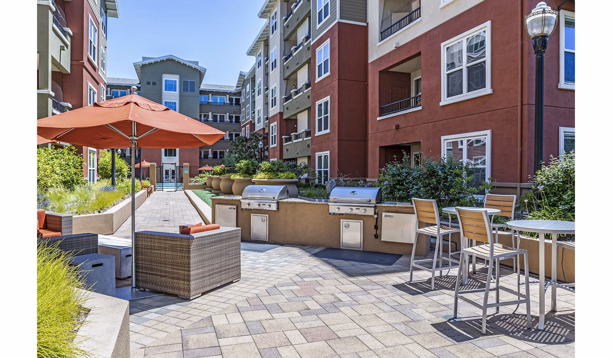 Outdoor grill area with modern cooking stations at Acappella Apartments