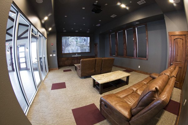 Movie room with plush seating and large screen at Camber Villas: perfect for entertainment and relaxation for residents