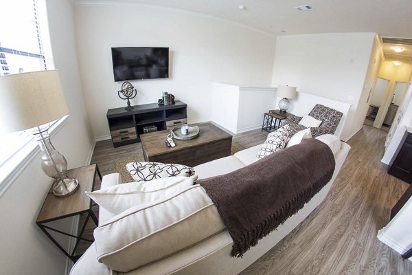 Modern living room with plush seating and large windows at Camber Villas luxury apartments