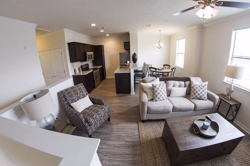 Spacious living room with modern furnishings in Camber Villas apartments
