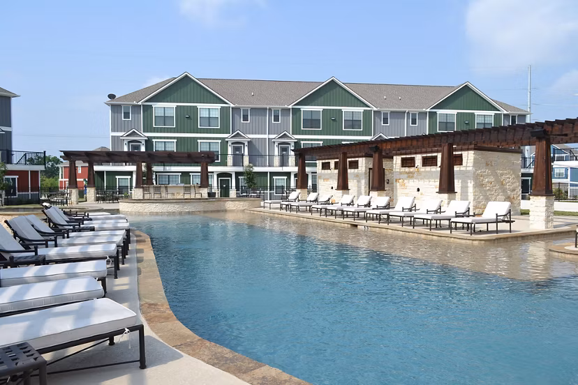 Resort-style outdoor pool at Camber Villas apartments offering luxury relaxation and leisure amenities