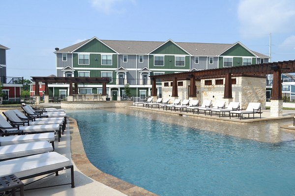 Resort-style outdoor pool at Camber Villas apartments offering luxury relaxation and leisure amenities