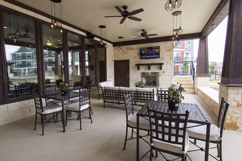 Elegant outdoor patio area with comfy seating at Camber Villas apartments, perfect for relaxation and social gatherings