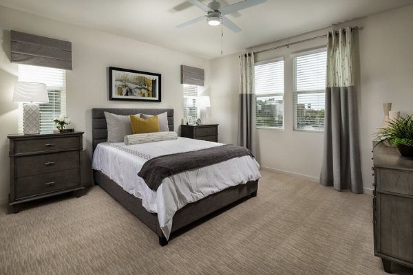 Elegant bedroom with plush bedding and designer accents at Terrano Apartments, luxurious dwelling in the heart of San Diego