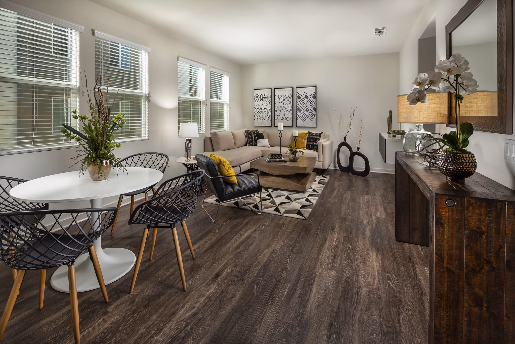 Dining room with contemporary lighting and sleek furnishings at Terrano Apartments
