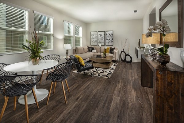 Dining room with contemporary lighting and sleek furnishings at Terrano Apartments