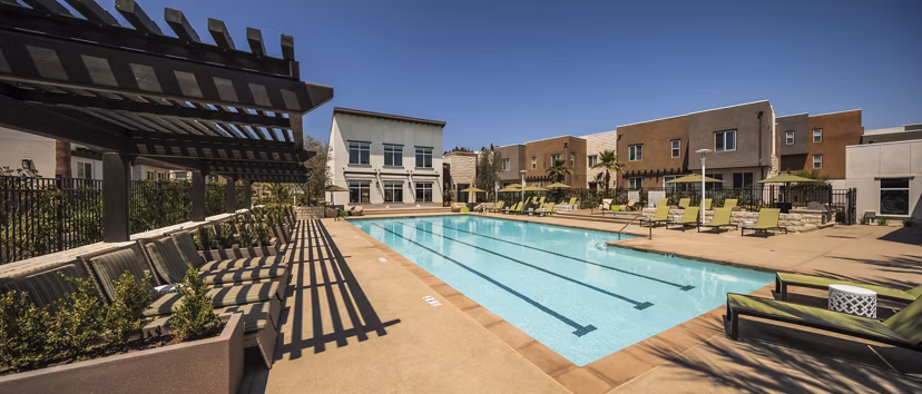 Luxurious pool with sun loungers at Terrano Apartments, perfect for relaxation in a sophisticated setting
