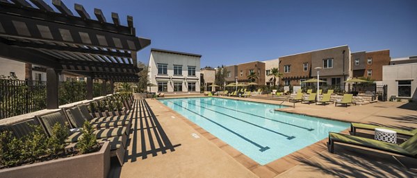 Luxurious pool with sun loungers at Terrano Apartments, perfect for relaxation in a sophisticated setting
