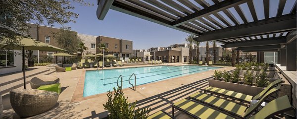 Resort-style pool with lounge chairs at Terrano Apartments in San Diego
