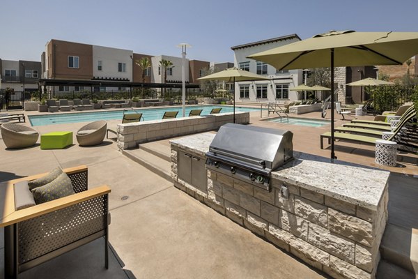 Outdoor grill and pool area at Terrano Apartments offering luxury amenities for residents