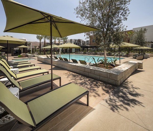 Luxurious outdoor pool area with lounge chairs at Terrano Apartments, San Diego, perfect for relaxation and recreation