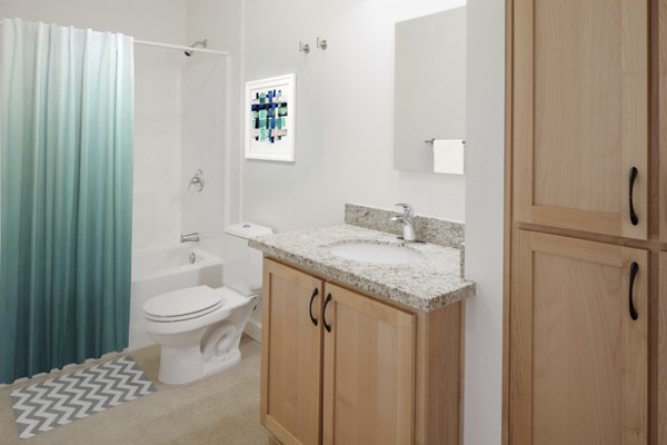 Crescent Village Apartments: Modern bathroom with sleek fixtures and ample lighting in luxury apartments