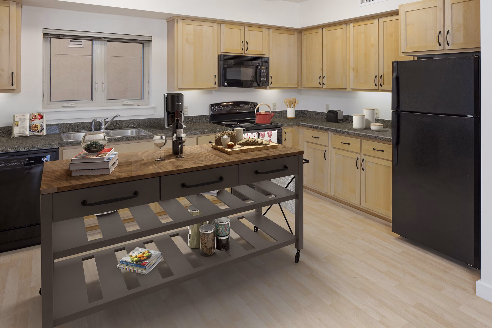 Spacious kitchen with modern appliances and island at Crescent Village Apartments