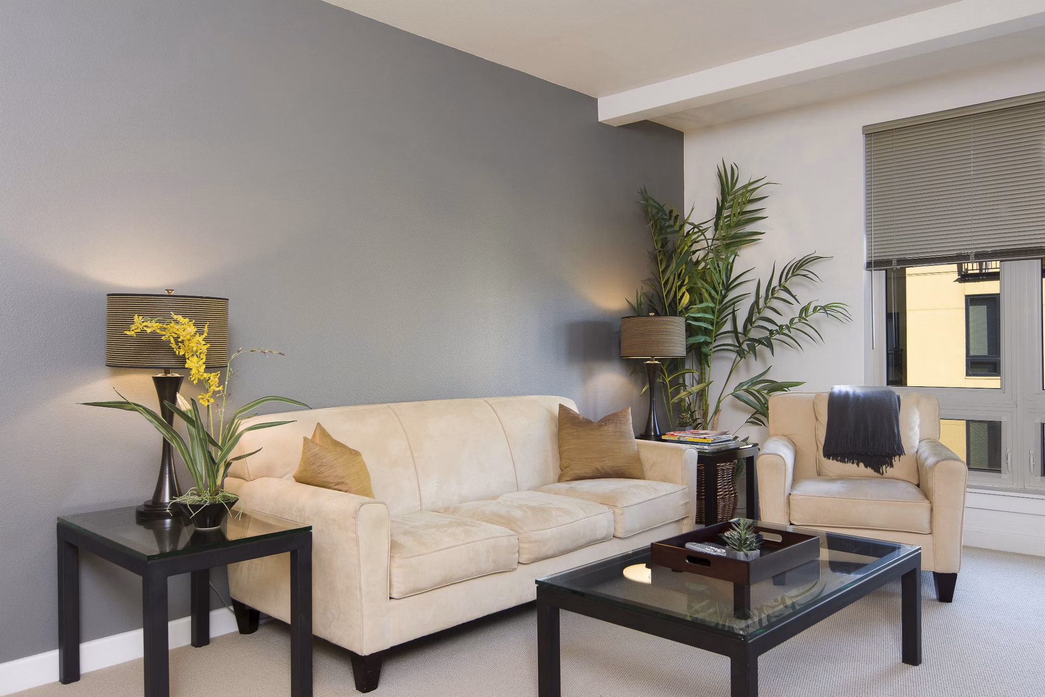 Modern living room with large windows and stylish furnishings at Crescent Village Apartments, a luxury apartment community