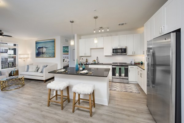 Modern kitchen featuring stainless steel appliances and granite countertops at Anchor Riverwalk Apartments