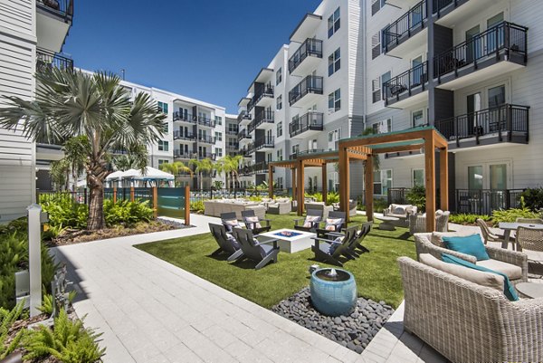 Resort-style pool surrounded by lush landscaping at Anchor Riverwalk Apartments, perfect for relaxation and leisure