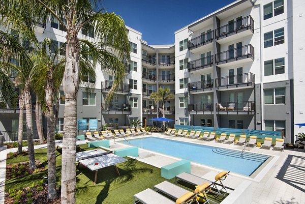 Resort-style pool with lounge chairs at Anchor Riverwalk Apartments, ideal for relaxation and leisure activities