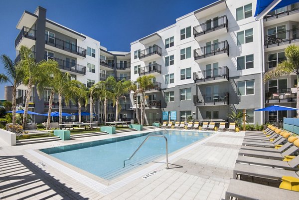 Resort-style pool at Anchor Riverwalk Apartments featuring luxurious lounging areas