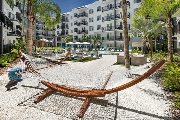 Poolside leisure area with stylish loungers at Anchor Riverwalk Apartments, offering luxury amenities for residents seeking relaxation and recreation