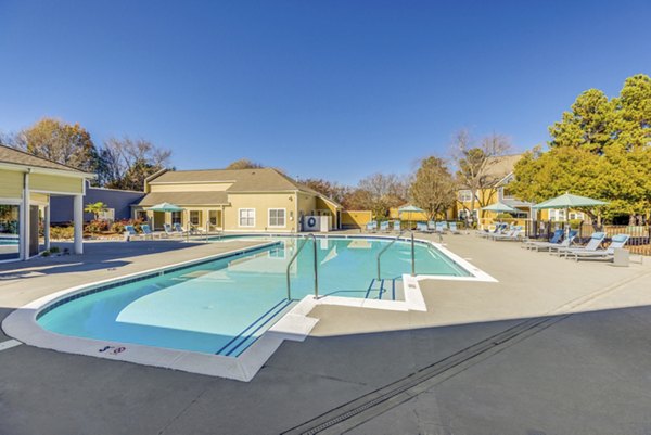 Resort-style pool with lounge chairs at The Arboretum Apartments offers luxury living experience