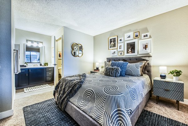 Stylish bedroom with modern decor and ample natural light at CIRC Apartments