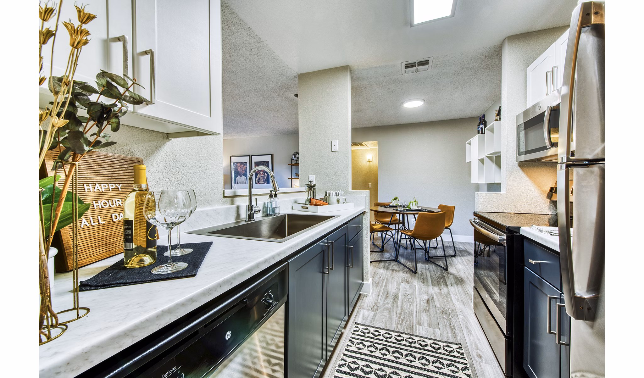 Modern kitchen with sleek countertops and stainless steel appliances at CIRC Apartments, luxury living by Greystar