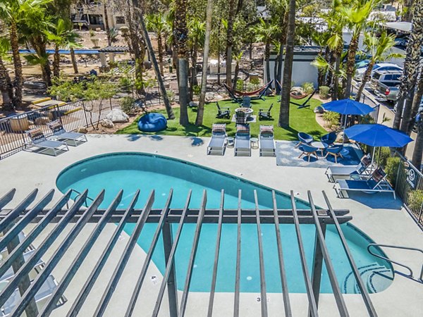 Poolside relaxation at Greystar's CIRC Apartments with luxurious seating and a beautifully landscaped pool area