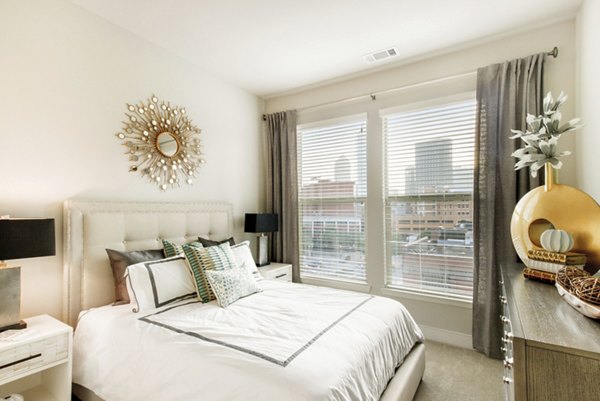 Cozy bedroom with contemporary design at 555 Ross Apartments