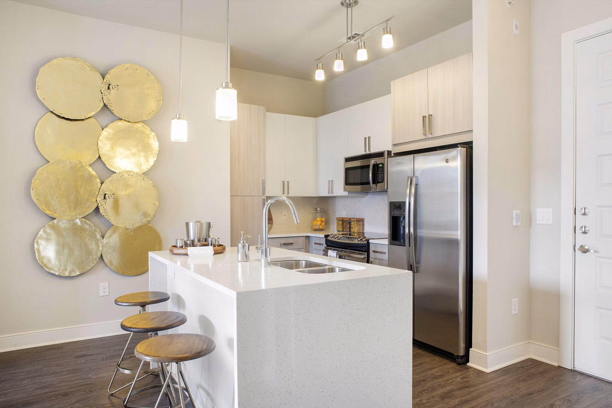 Modern kitchen with stainless steel appliances at 555 Ross Apartments, luxury living in the heart of a vibrant community