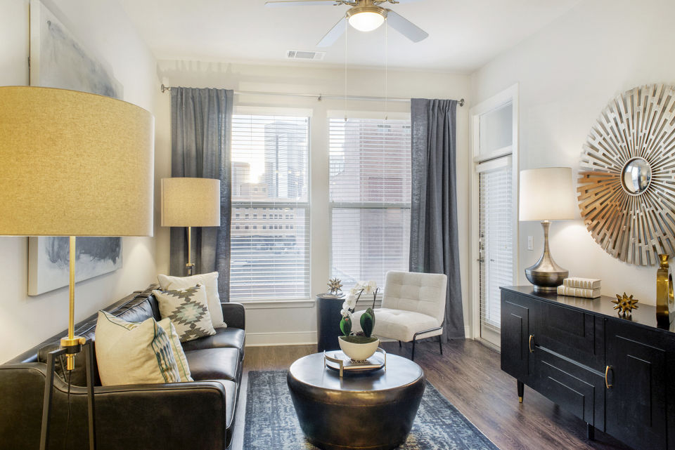 Spacious living room with modern decor and large windows at 555 Ross Apartments, a Greystar luxury residence in urban setting