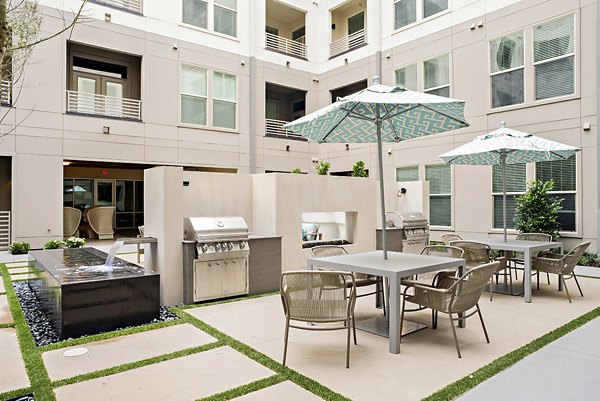 Modern outdoor grill area with stainless steel appliances at 555 Ross Apartments, ideal for luxury entertaining in a vibrant community setting