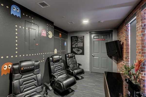 Game room with pool table and arcade games at Shorewood Heights Apartments