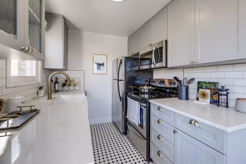Modern kitchen with stainless steel appliances in Shorewood luxury apartments