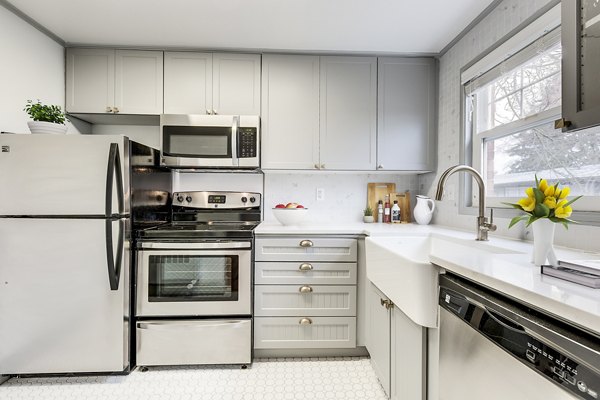 Modern kitchen featuring stainless steel appliances and sleek countertops in Shorewood Apartments
