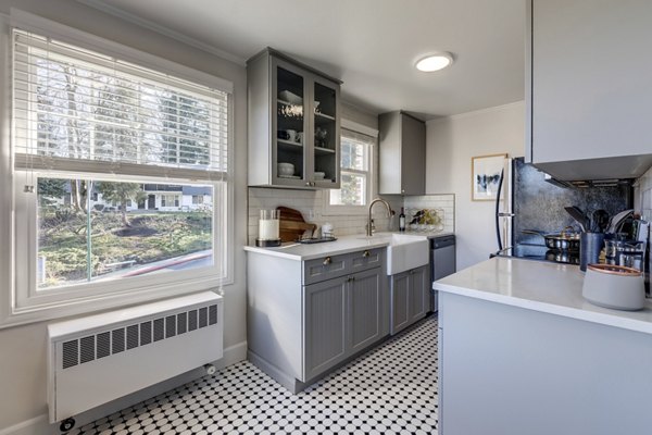 Modern kitchen with granite countertops and stainless-steel appliances in Shorewood luxury apartments