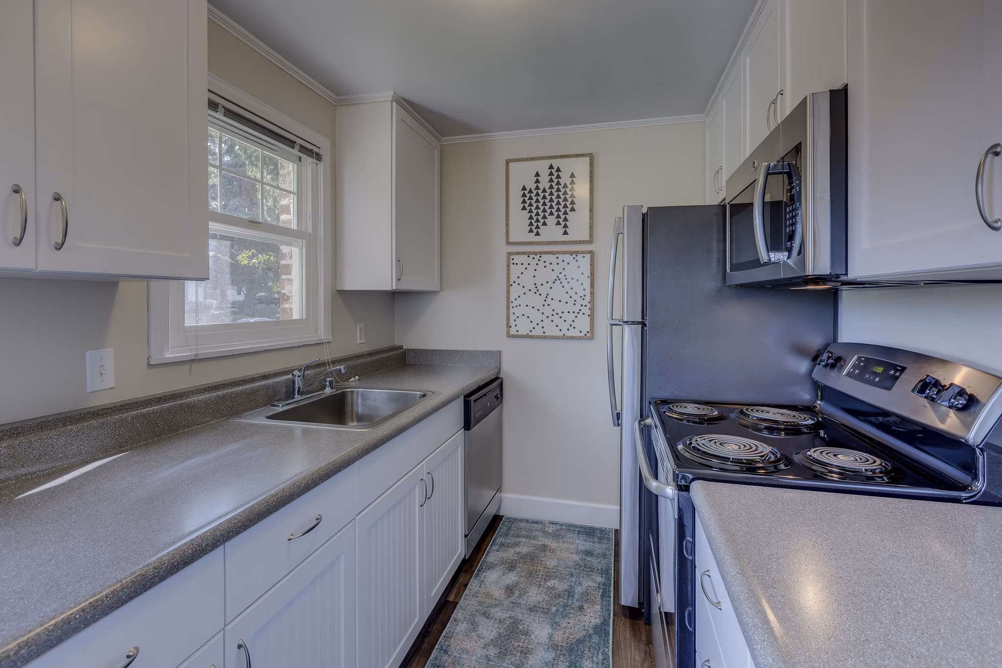 Modern kitchen with stainless steel appliances and sleek countertops at Shorewood Heights Apartments