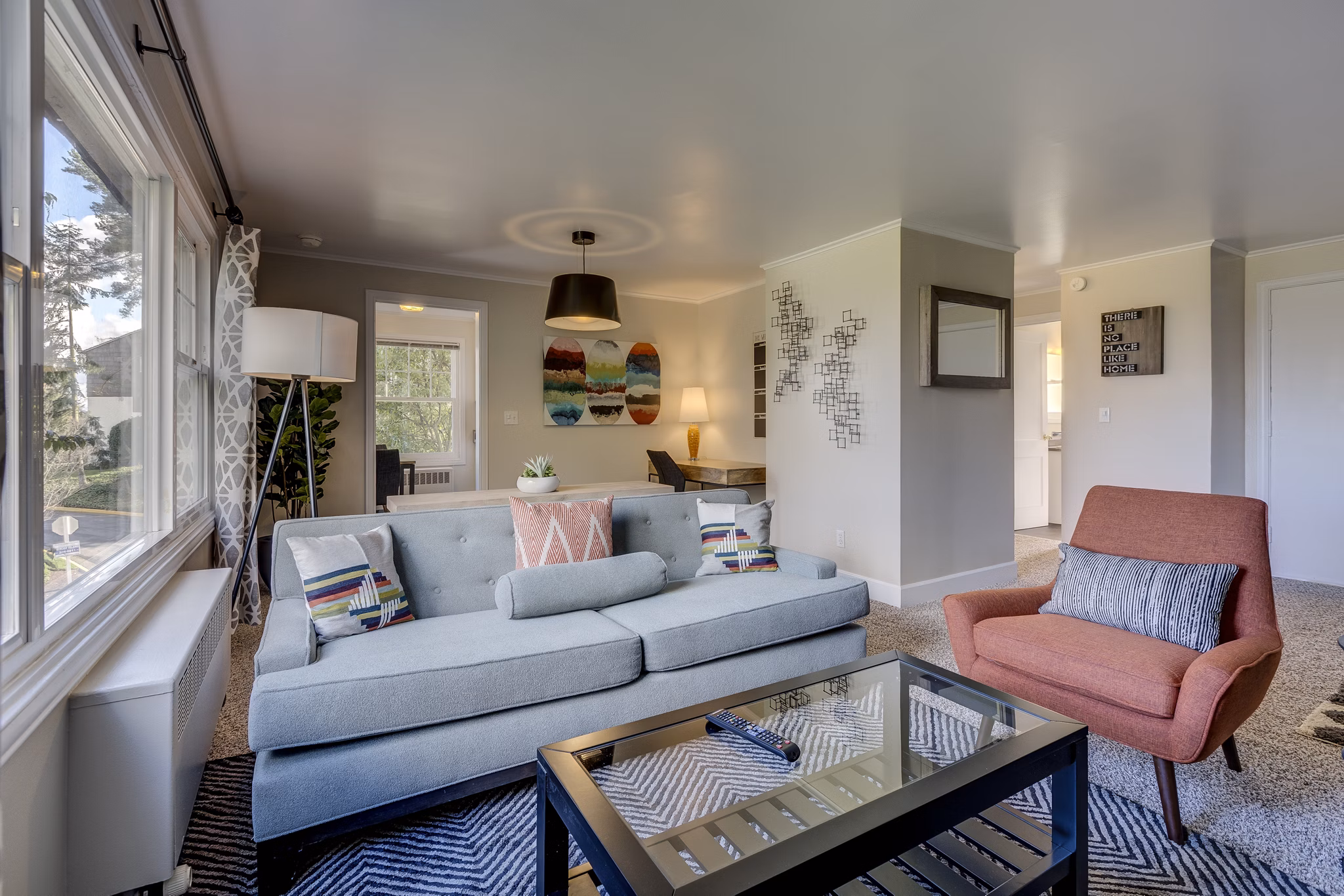 Living room with modern decor and large windows at Shorewood Heights Apartments