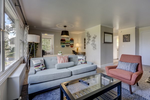 Living room with modern decor and large windows at Shorewood Heights Apartments