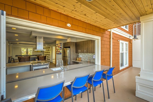 Outdoor patio area with modern seating and lush landscaping at Shorewood Heights Apartments, ideal for relaxation and entertainment