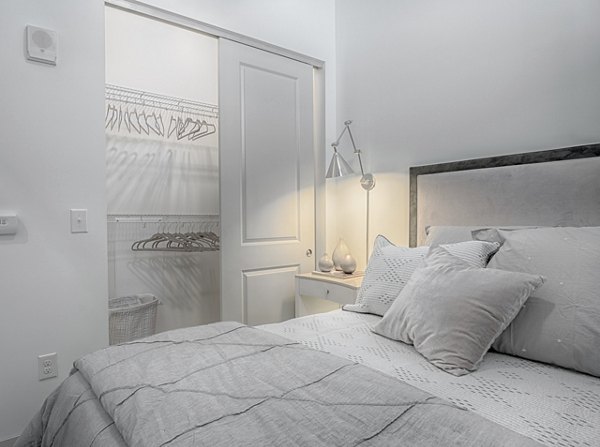 Spacious bedroom with elegant decor at Main & Clay Apartments in Louisville