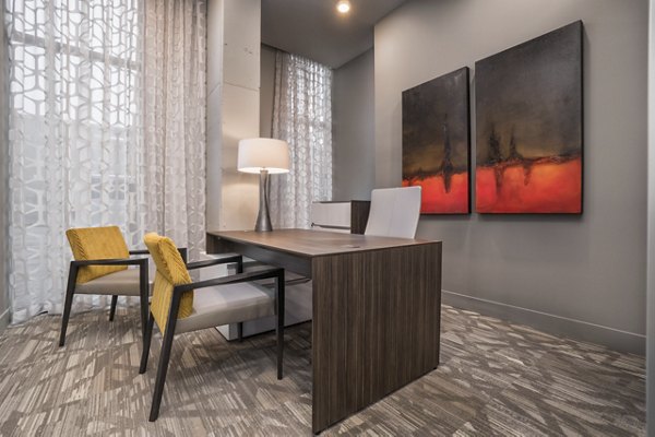 Clubhouse featuring modern design and ample seating at Main & Clay Apartments in Louisville